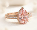 Pear cut pink diamond engagement ring with a pavé band