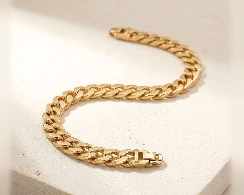 Gold plated Cuban link bracelet on ivory fabric